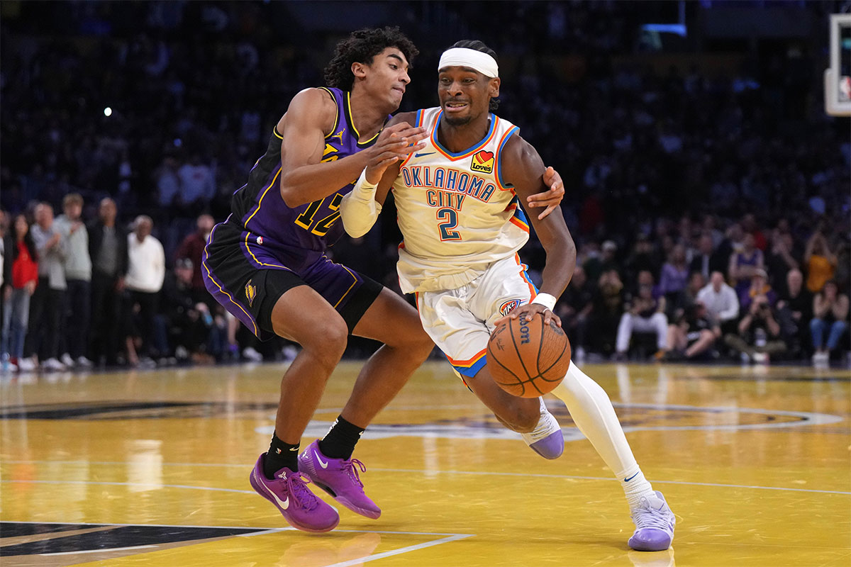 Thunder guard Shai Gilgeous-Alexander (2) dribbles against Los Angeles Lakers guard Austin Reaves (15) in the second half at Crypto.com Arena