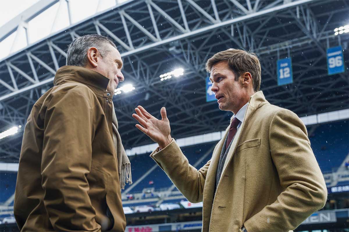 Former New England Patriots quarterbacks Drew Bledsoe, left, and Tom Brady, right, talk during pregame warmups between the Seattle Seahawks and Buffalo Bills at Lumen Field.