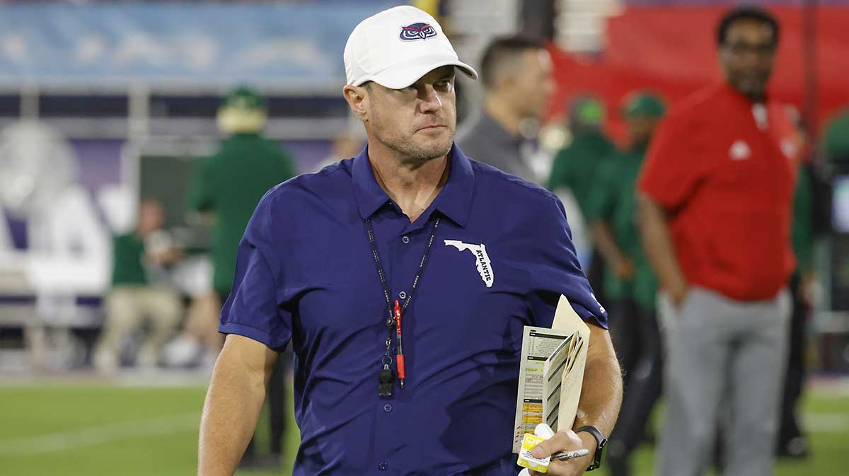 Florida Atlantic Owls head coach Tom Herman walks on the field before the game against the South Florida Bulls at FAU Stadium.