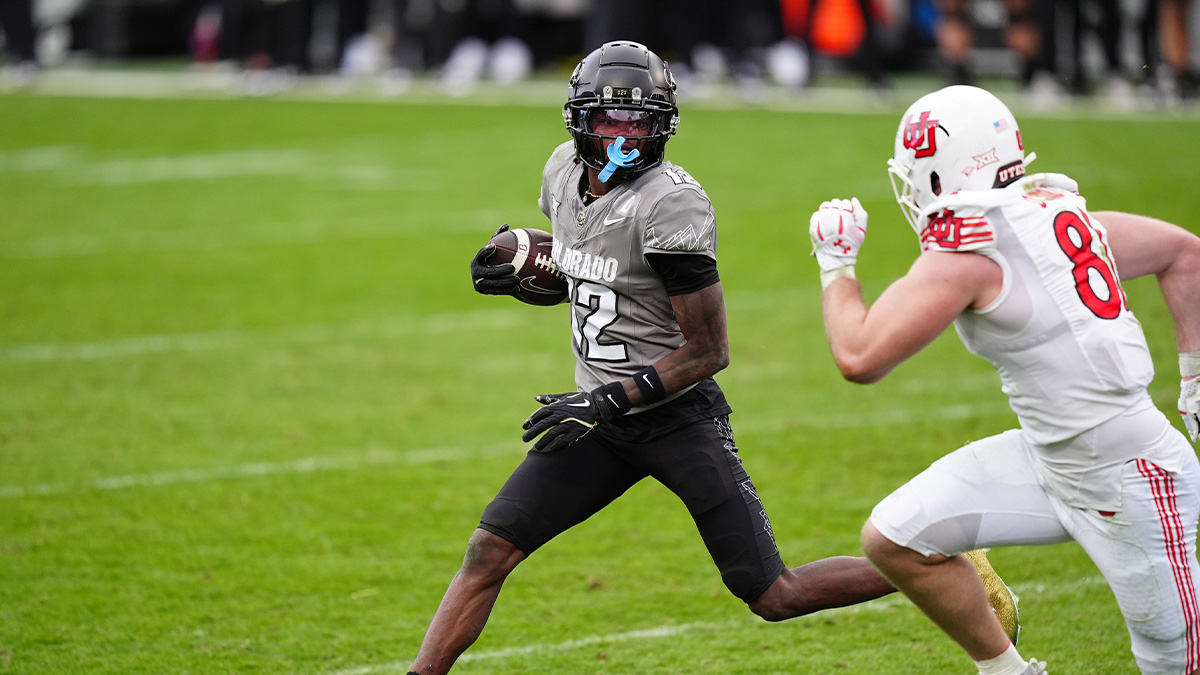 Colorado Buffaloes wide receiver Travis Hunter (12) carries the ball for a touchdown in the fourth quarter against the Utah Utes at Folsom Field.