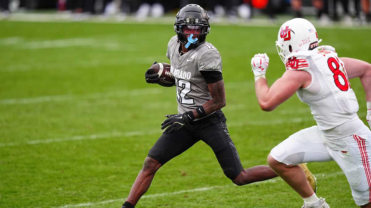 Colorado Buffaloes wide receiver Travis Hunter (12) carries the ball for a touchdown in the fourth quarter against the Utah Utes at Folsom Field.