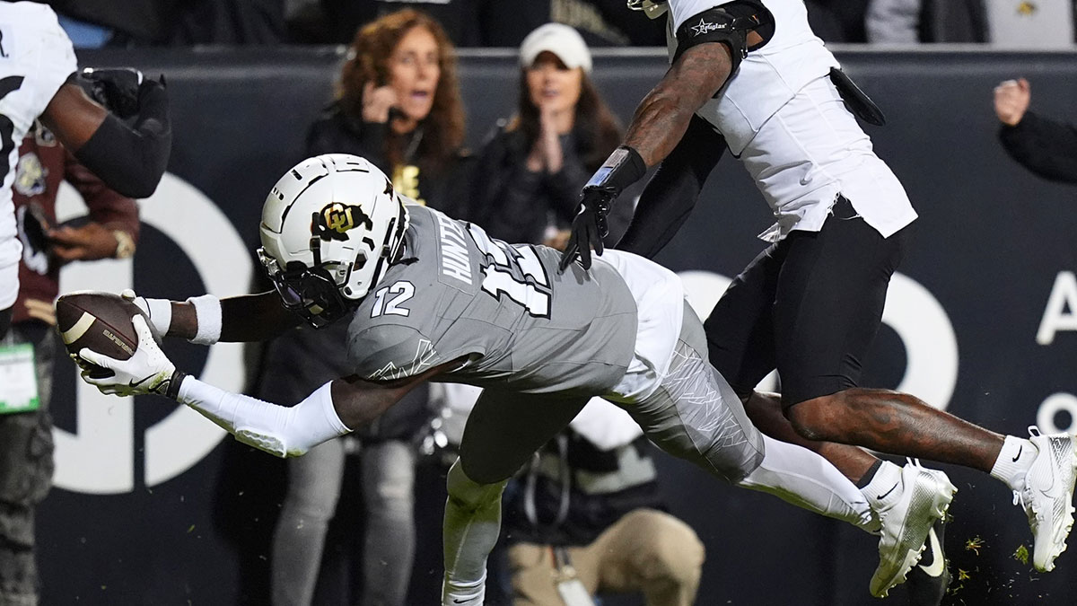 Colorado Buffaloes wide receiver Travis Hunter (12) dives for a touchdown in the second quarter against the Cincinnati Bearcats at Folsom Field.