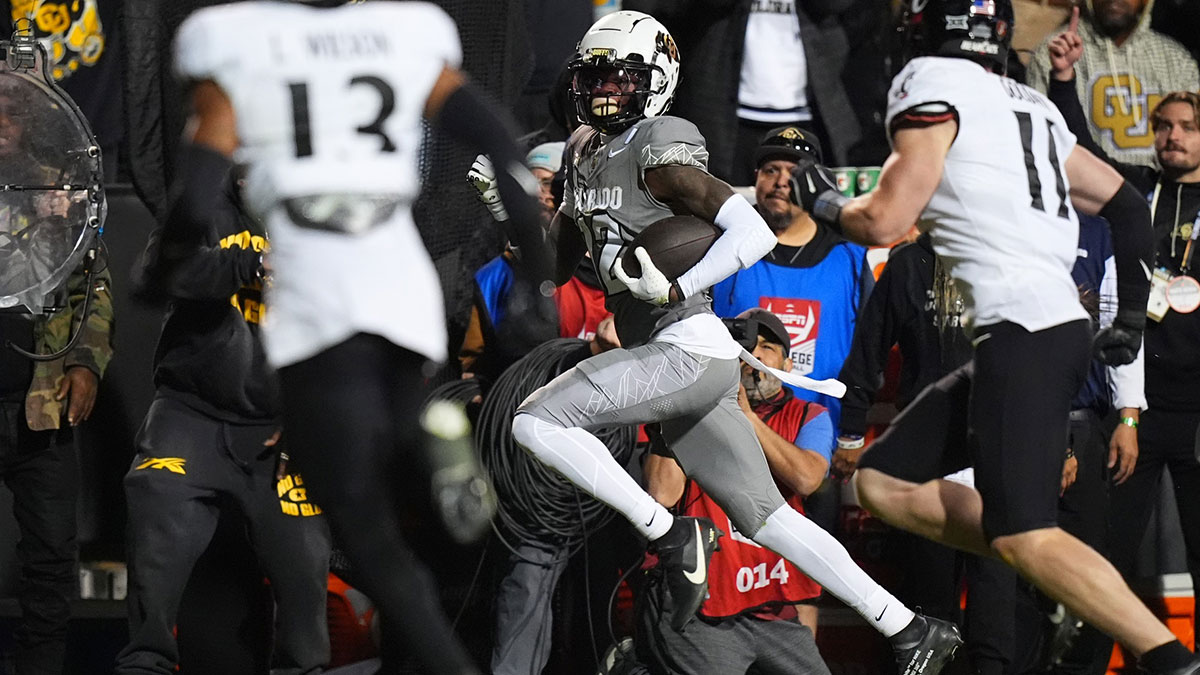 Colorado Buffaloes wide receiver Travis Hunter (12) carries the ball in the second quarter against the Cincinnati Bearcats at Folsom Field.