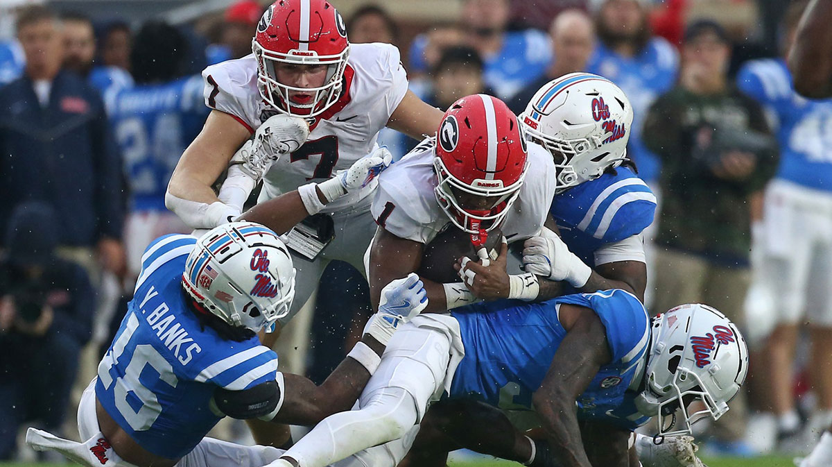 Georgia Bulldogs running back Trevor Etienne (1) runs the ball as Mississippi Rebels defensive back Trey Amos (9) makes the tackle during the first half at Vaught-Hemingway Stadium