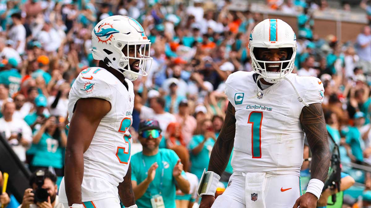 Miami Dolphins running back Raheem Mostert (31) celebrates with quarterback Tua Tagovailoa (1) after scoring a touchdown against the Arizona Cardinals at Hard Rock Stadium.