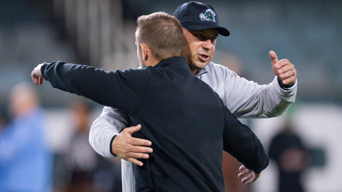 Tulane Green Wave head coach Jon Sumrall, right, greets Memphis Tigers head coach Ryan Silverfield before the start of the game at Yulman Stadium.