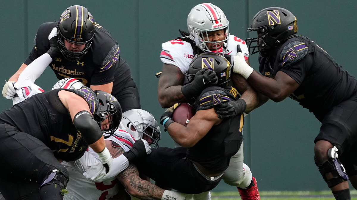 Ohio State Buckeyes defensive tackle Tyleik Williams (91) tackles Northwestern Wildcats running back Cam Porter (1) during the NCAA football game at Wrigley Field in Chicago on Monday, Nov. 18, 2024. Ohio State won 31-7.