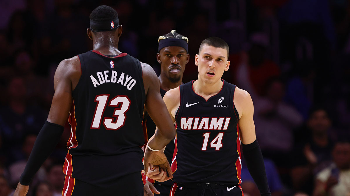 Miami Heat guard Tyler Herro (14) celebrates with Miami Heat center Bam Adebayo (13) after scoring against the Sacramento Kings during the fourth quarter at Kaseya Center.