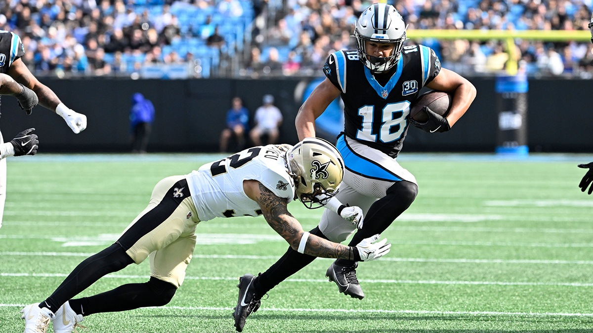Carolina Panthers wide receiver Jalen Coker (18) with the ball as New Orleans Saints safety Tyrann Mathieu (32) defends in the second quarter at Bank of America Stadium.
