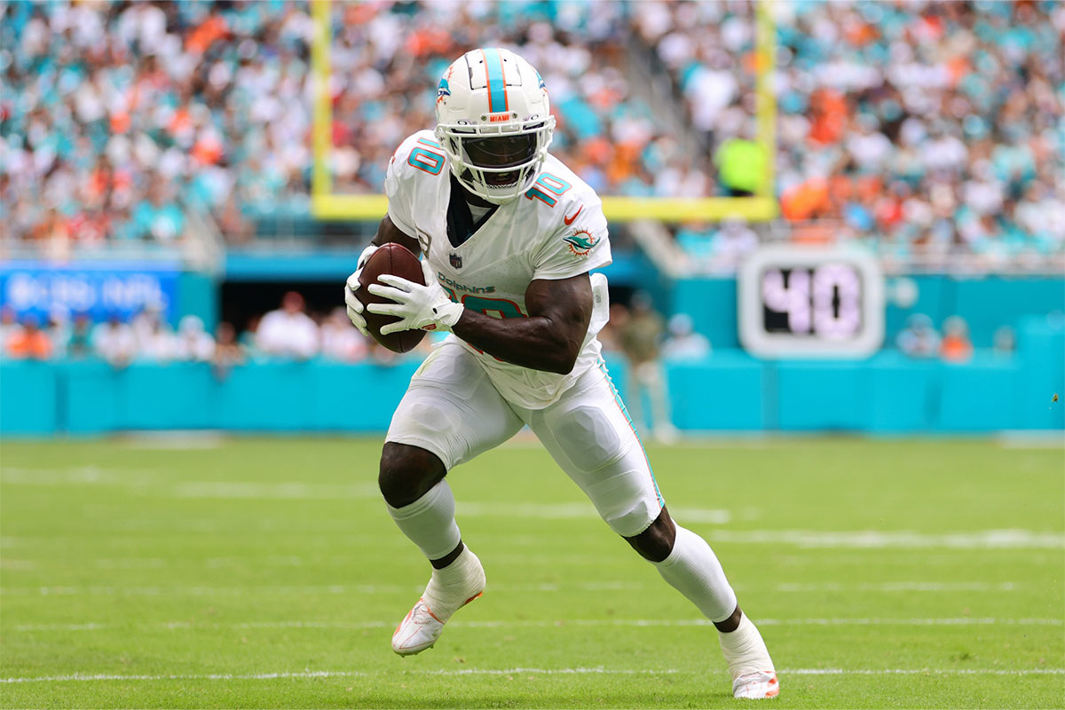Miami Dolphins wide receiver Tyreek Hill (10) runs with the football against the Las Vegas Raiders during the first quarter at Hard Rock Stadium.