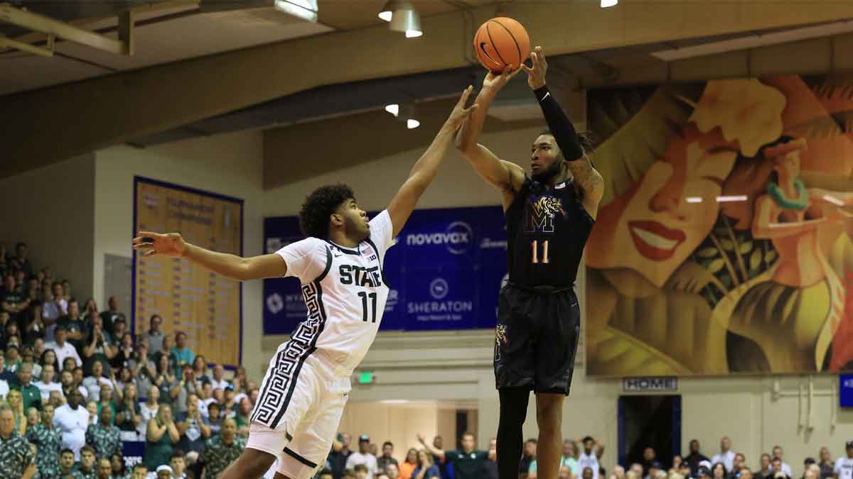 Memphis Tigers guard Tyrese Hunter (11) makes a three point shot and is fouled by Michigan State Spartans guard Jase Richardson (11) in the second half at Lahaina Civic Center.