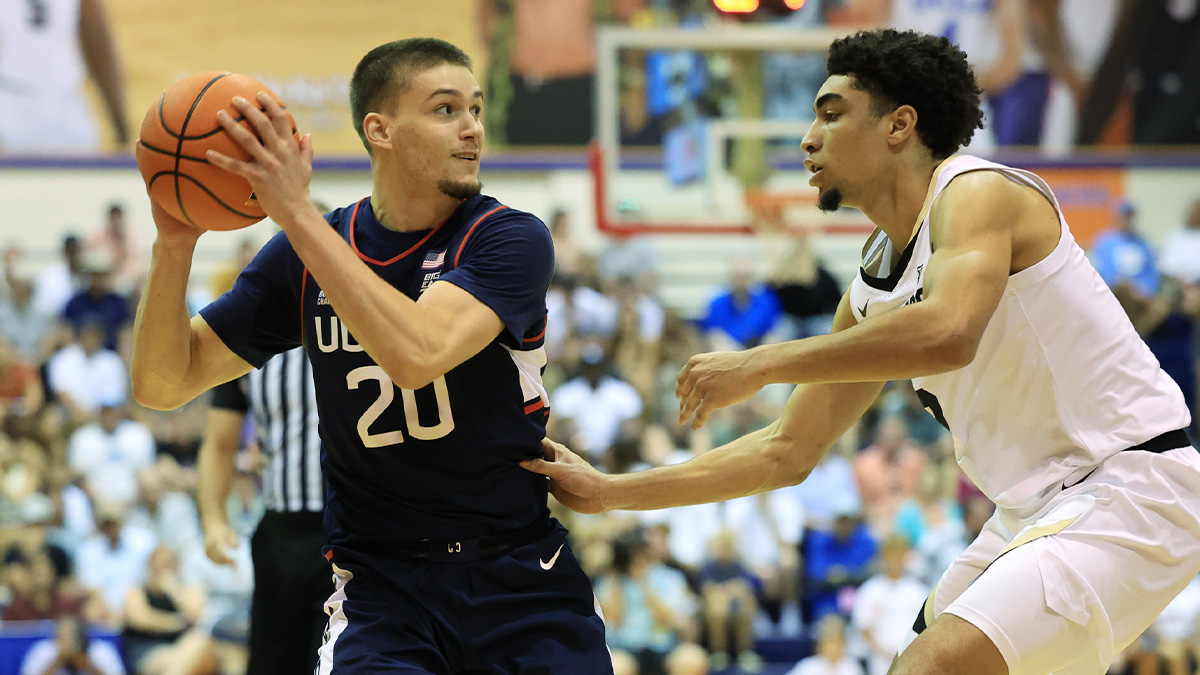 Colorado Buffaloes guard RJ Smith (5) guards Connecticut Huskies guard Aidan Mahaney (20) during the first half of an NCAA college basketball game at Lahaina Civic Center.