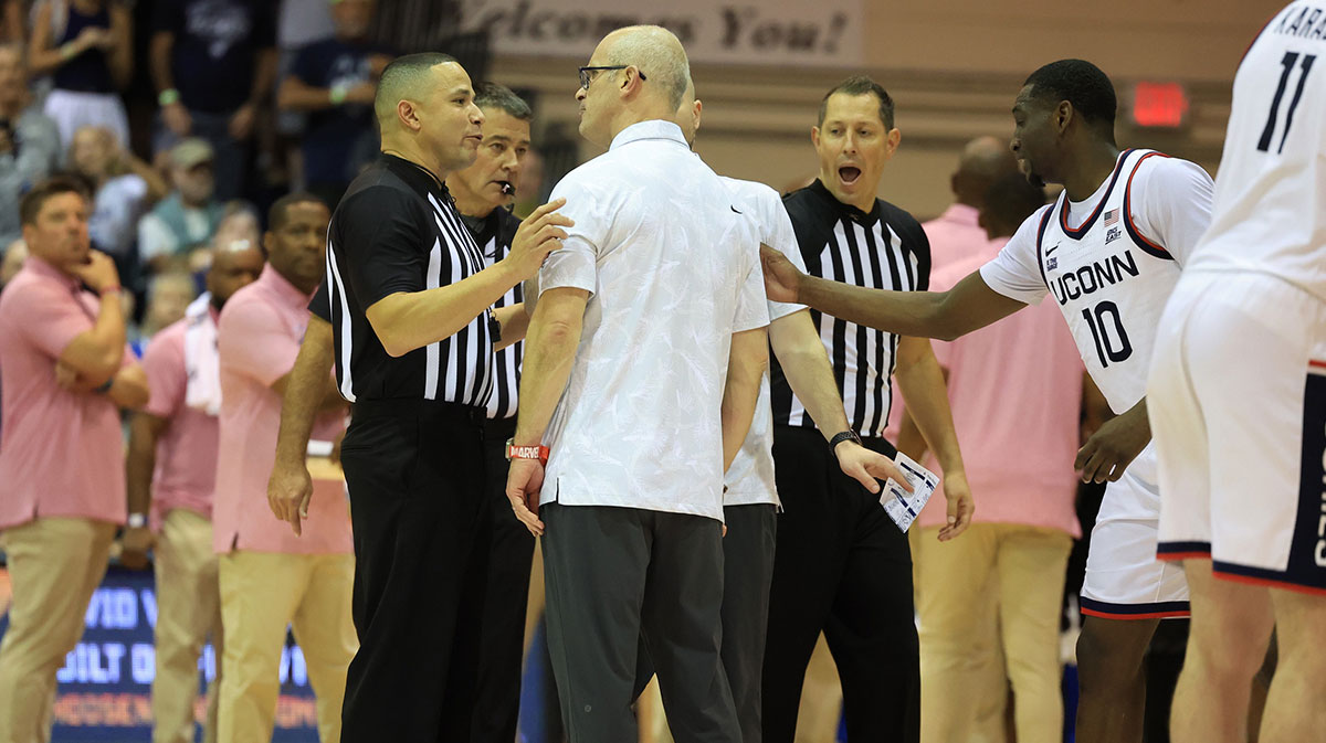 Connecticut Huskies head coach Dan Hurley, center, reacts with officials during overtime in an NCAA college basketball game against the Memphis Tigers at Lahaina Civic Center