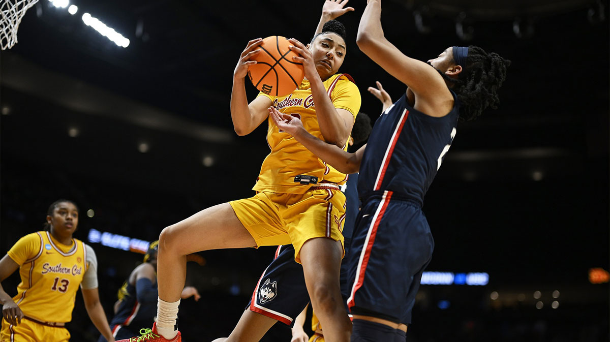 USC Trojans guard JuJu Watkins (12) grabs a rebound against UConn Huskies guard KK Arnold (2) during the first half of the Portland Regional final of the 2024 NCAA Tournament. 