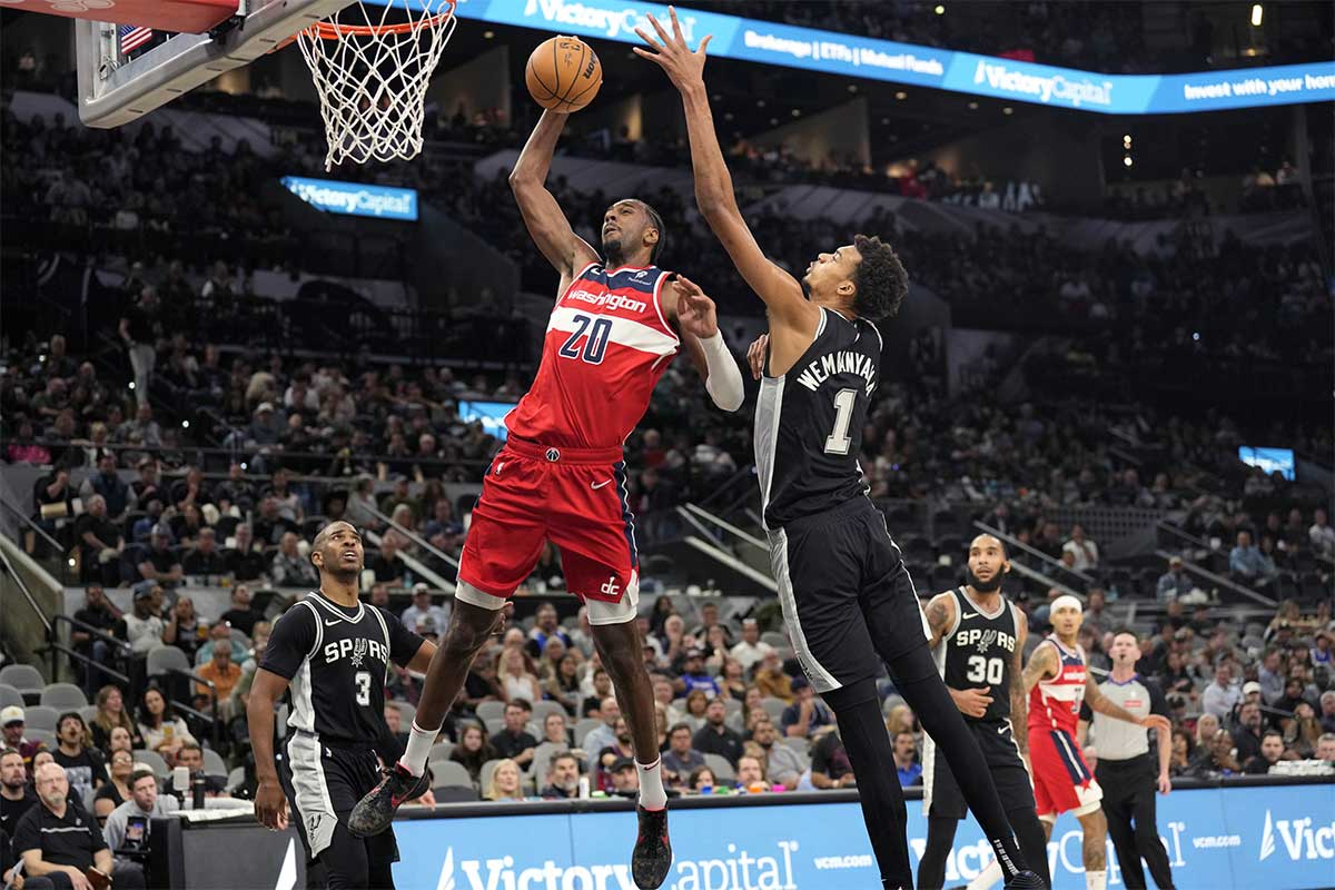 Washington Wizards forward Alex Sarr (20) goes up to dunk while defended by San Antonio Spurs center Victor Wembanyama (1) during the second half at Frost Bank Center.