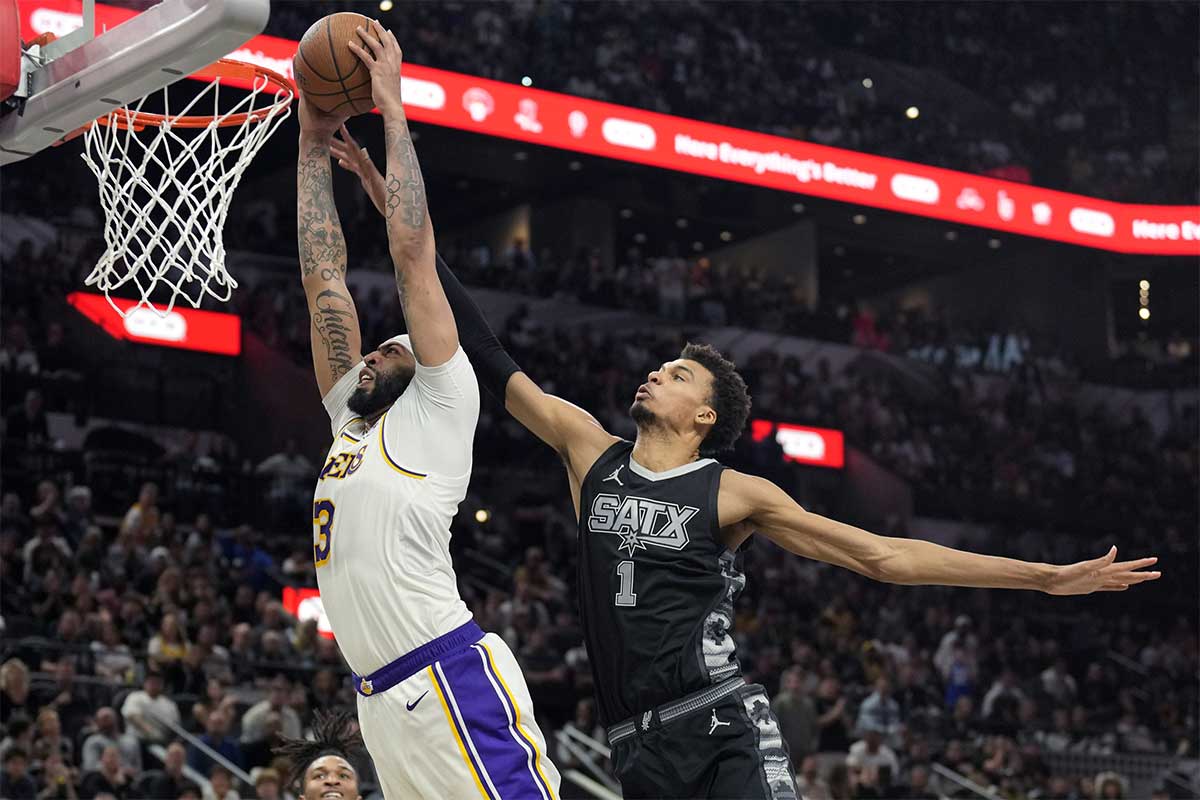 Los Angeles Lakers forward Anthony Davis (3) goes up to dunk past San Antonio Spurs center Victor Wembanyama (1) during the second half at Frost Bank Center. 