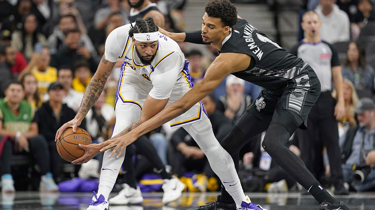 Nov 15, 2024; San Antonio, Texas, USA; Los Angeles Lakers forward Anthony Davis (3) looks to pass the ball while defended by San Antonio Spurs center Victor Wembanyama (1) during the first half during the first half at Frost Bank Center. Mandatory Credit: Scott Wachter-Imagn Images