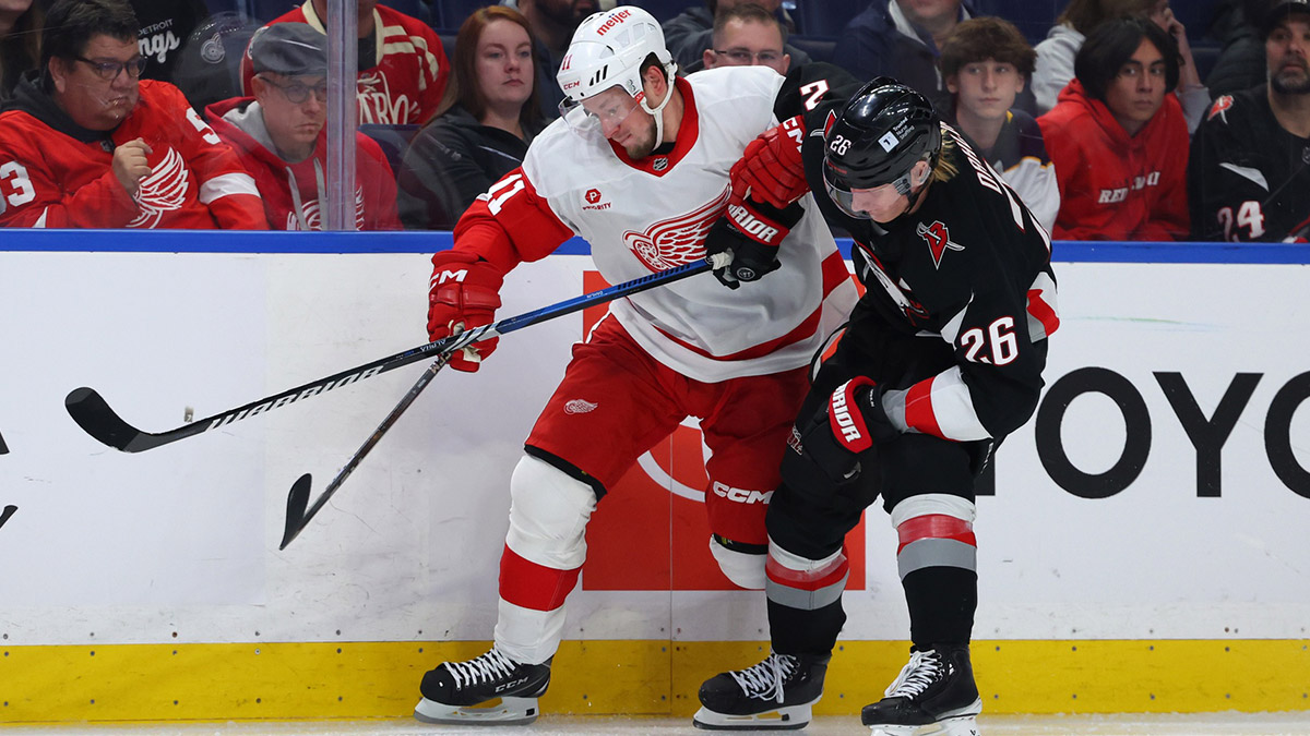 Detroit Red Wings right winger Vladimir Tarasenko (11) and Buffalo Sabers defenseman Rasmus Dahlin (26) go after a loose puck in the third period at KeyBank Center.