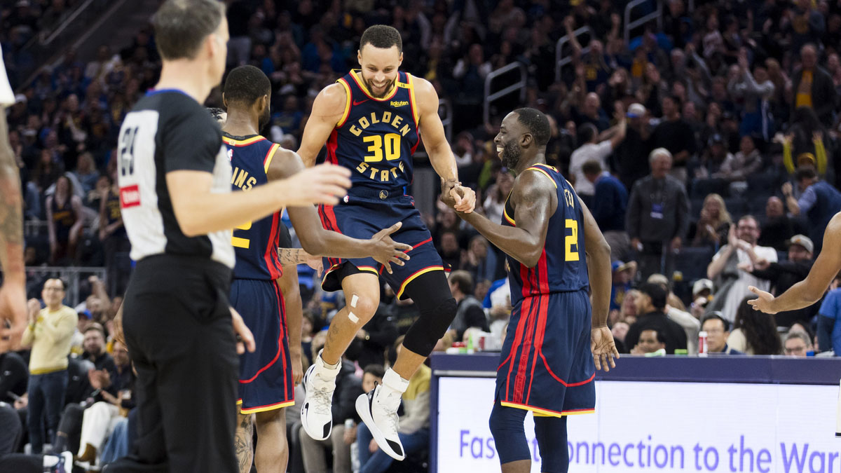 Golden State Warriors guard Stephen Curry (30) is helped up after being fouled on a three-point shot against the Brooklyn Nets during the second half at Chase Center. 