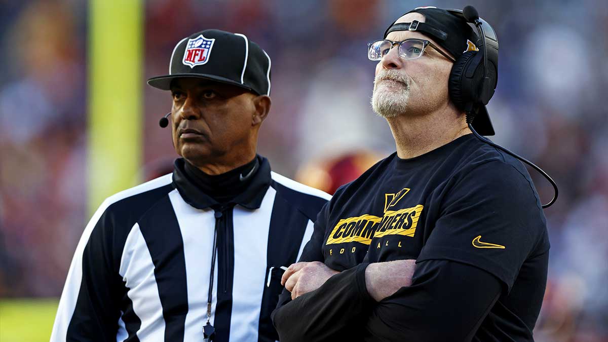 Washington Commanders head coach Dan Quinn watches a replay on the video board during the third quarter of the game against the Dallas Cowboys at Northwest Stadium.