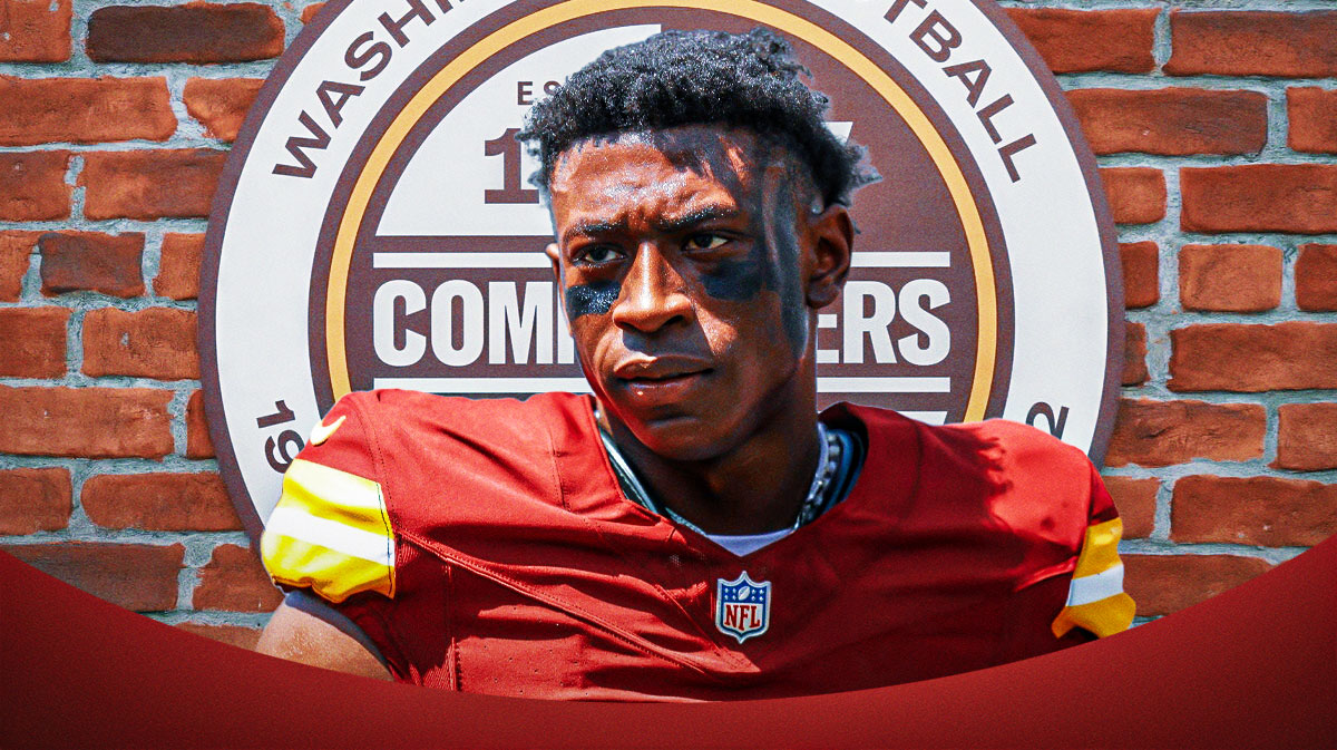 Commanders cornerback Emmanuel Forbes next to the Commanders logo