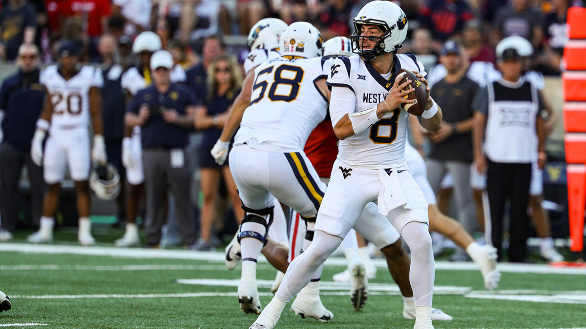 West Virginia Mountaineers quarterback Nicco Marchiol (8) looks to throw the ball during the first quarter against the Arizona Wildcats at Arizona Stadium.