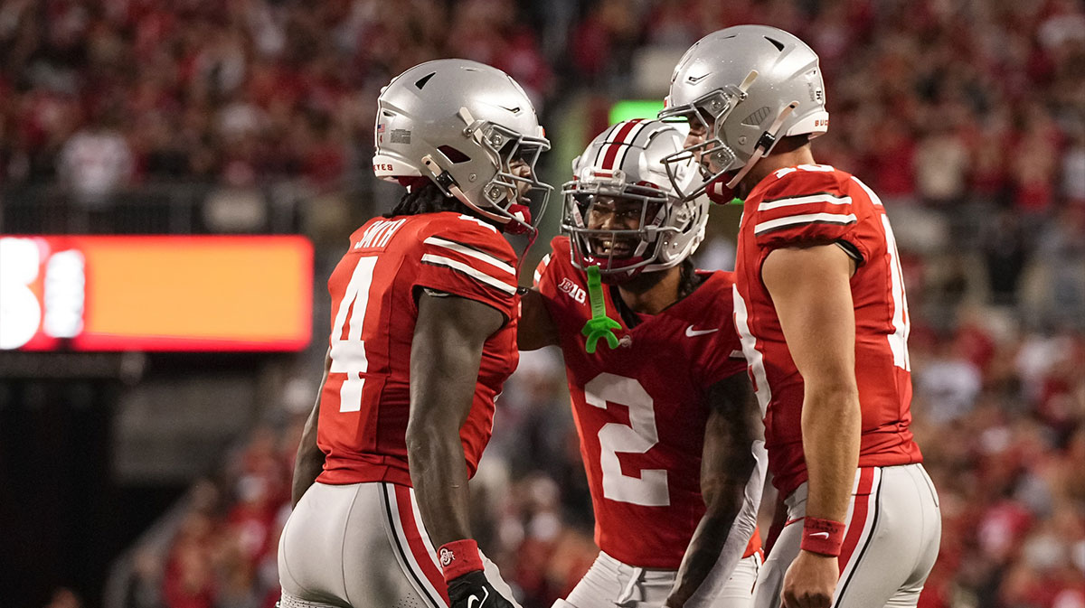 Ohio State Buckeyes wide receiver Jeremiah Smith (4) celebrates with wide receiver Emeka Egbuka (2) and quarterback Will Howard (18) after scoring a touchdown against the Western Michigan Broncos during the first half at Ohio Stadium.