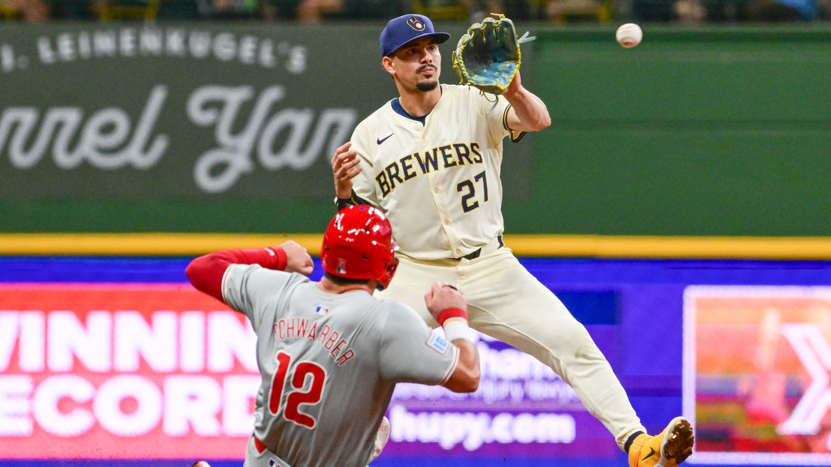 Milwaukee Brewers shortstop Willy Adames (27) forces out Philadelphia Phillies designated hitter Kyle Schwarber (12) in the eighth inning at American Family Field.