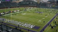 Players warm up before the game between the Northwestern Wildcats and the Iowa Hawkeyes at Wrigley Field.