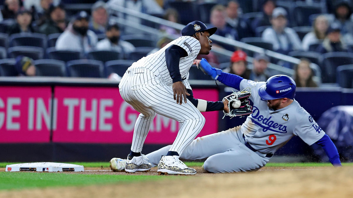 Los Angeles Dodgers second baseman Gavin Lux (9) slides into third base ahead of the tag of New York Yankees third baseman Jazz Chisholm Jr. (13) during the fourth inning in game three of the 2024 MLB World Series at Yankee Stadium.
