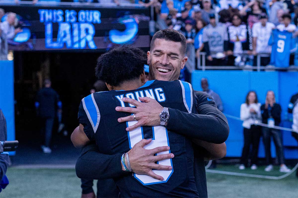 Carolina Panthers head coach Dave Canales hugs quarterback Bryce Young (9) after getting the win against the New Orleans Saints at Bank of America Stadium.