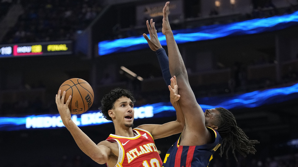 Atlanta Hawks forward Zaccharie Risacher (10) shoots the basketball against Golden State Warriors forward Kevon Looney (5) during the first quarter at Chase Center. 