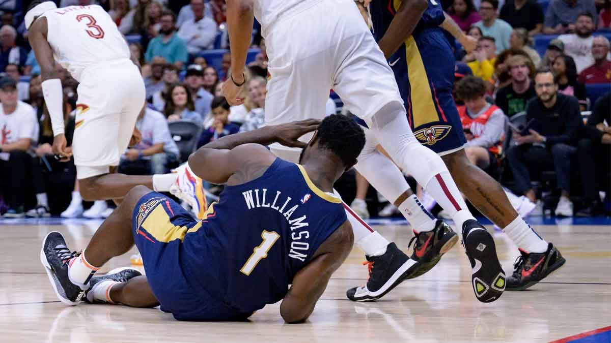 New Orleans Pelicans forward Zion Williamson (1) falls on the court against the Cleveland Cavaliers during the first half at Smoothie King Center.