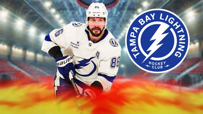 Nikita Kucherov looking happy with fire around him, Tampa Bay Lightning logo, hockey rink in background