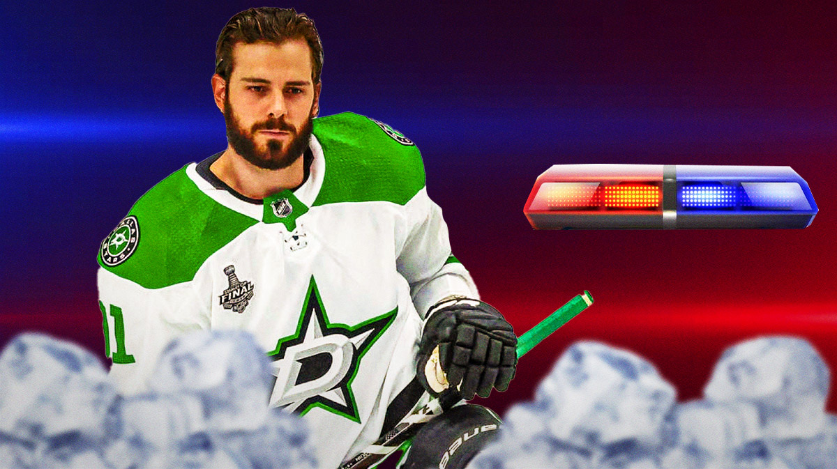 Stars center Tyler Seguin next to police lights