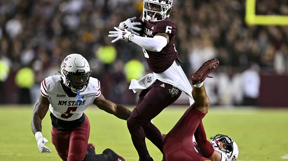 New Mexico State Aggies safety Tayden Barnes (3) and safety Nick Session (5) tackle Texas A&M Aggies wide receiver Cyrus Allen (6) during the first half at Kyle Field.
