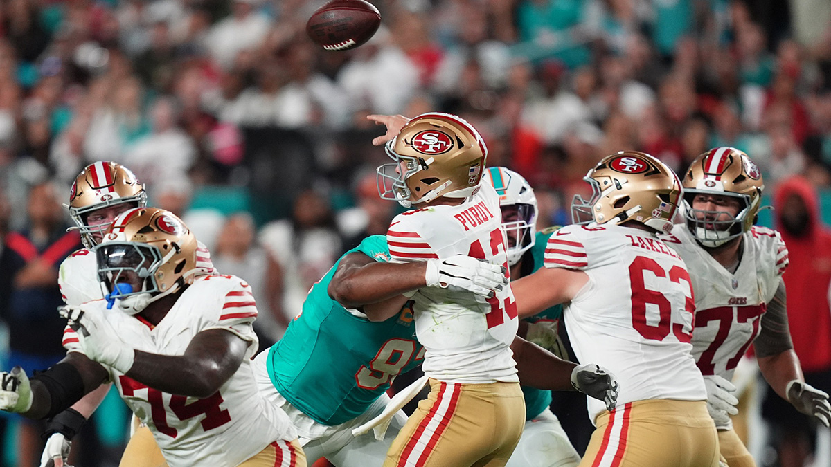 Miami Dolphins defensive tackle Calais Campbell (93) hits San Francisco 49ers quarterback Brock Purdy (13) on the pass attempt during second half at Hard Rock Stadium.