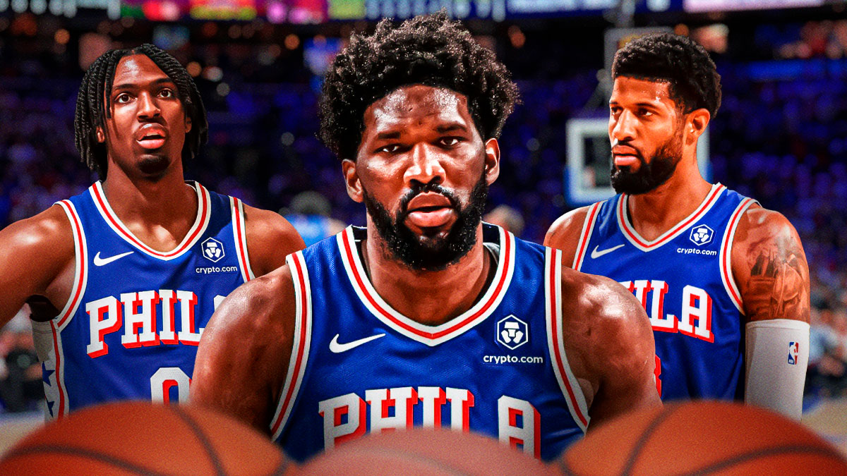 Philadelphia 76ers star Joel Embiid in the middle with Tyrese Maxey and Paul George on either side in front of the Wells Fargo Center.