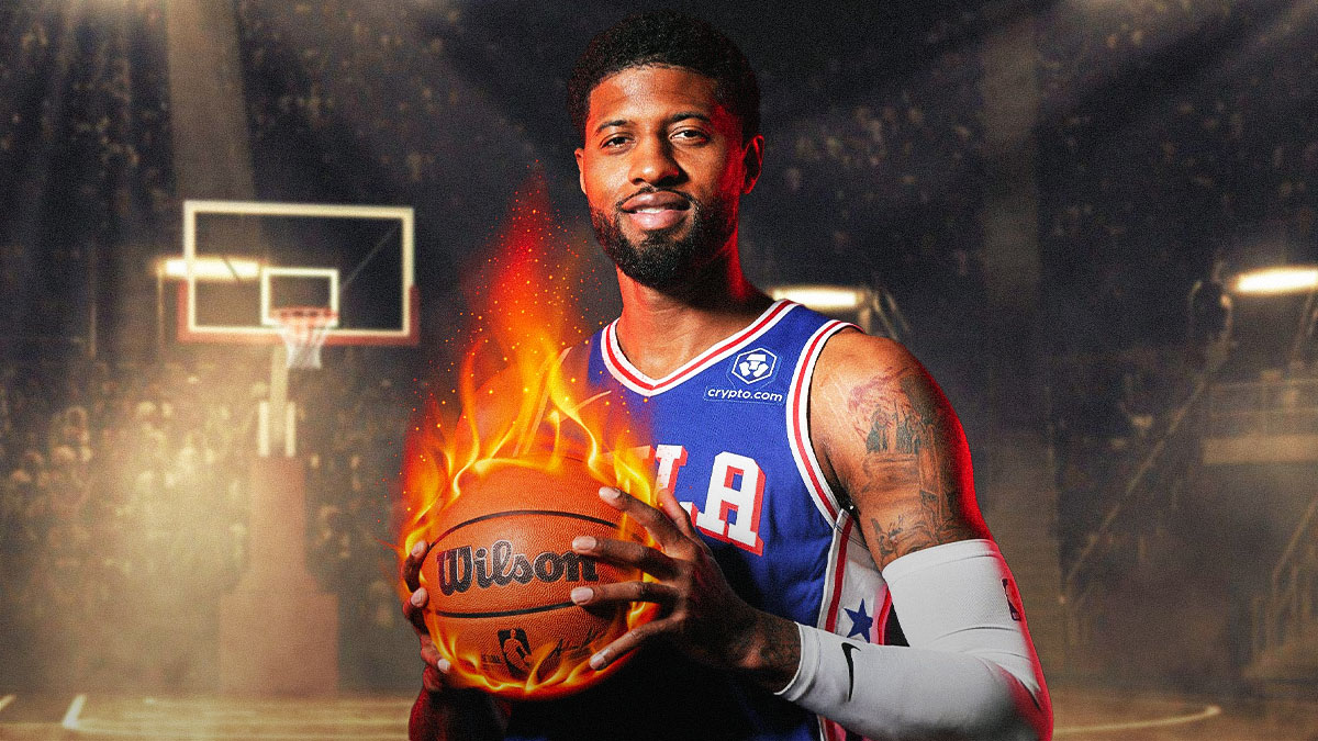 76ers' Paul George smiling while holding a fireball