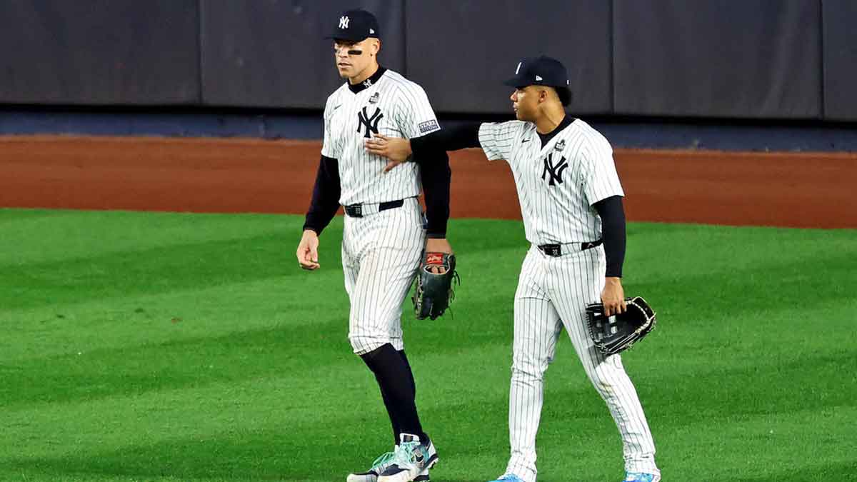 New York Yankees outfielder Juan Soto (22) reacts with outfielder Aaron Judge (99) after Judge dropped a fly ball during the fifth inning against the Los Angeles Dodgers during game five of the 2024 MLB World Series at Yankee Stadium.