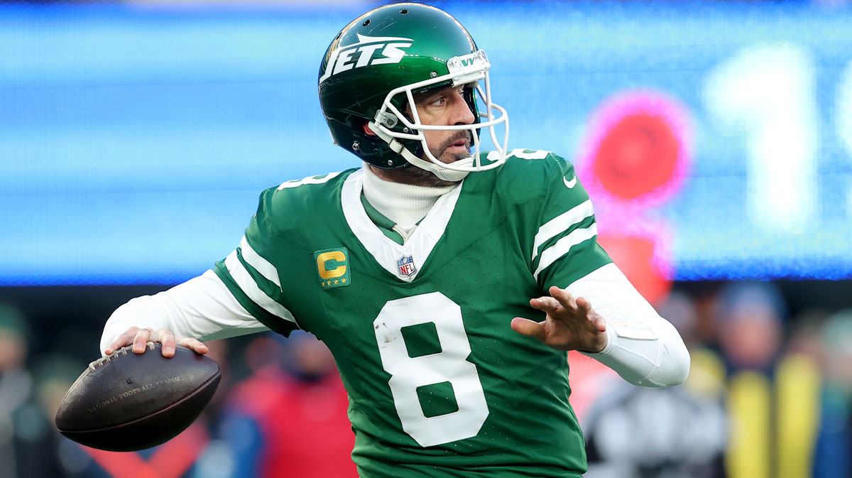 New York Jets quarterback Aaron Rodgers (8) drops back to pass against the Los Angeles Rams during the fourth quarter at MetLife Stadium.