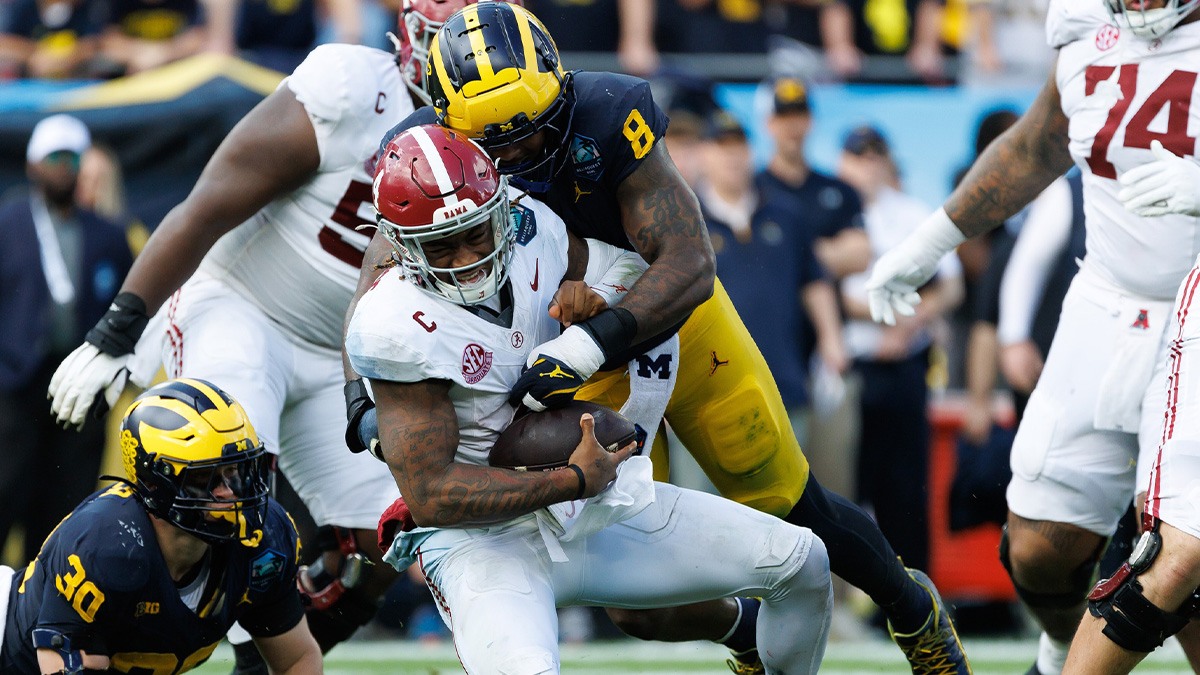 Michigan Wolverines defensive end Derrick Moore (8) sacks Alabama Crimson Tide quarterback Jalen Milroe (4) during the first half at Raymond James Stadium.