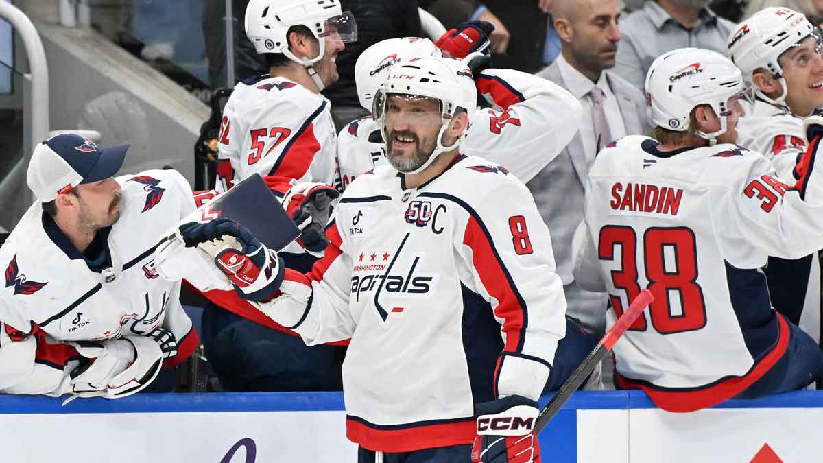 Washington Capitals forward Alex Ovechkin (8) celebrates with goaltender Charlie Lindgren (79) on the bench after scoring against the Toronto Maple Leafs in the third period at Scotiabank Arena.