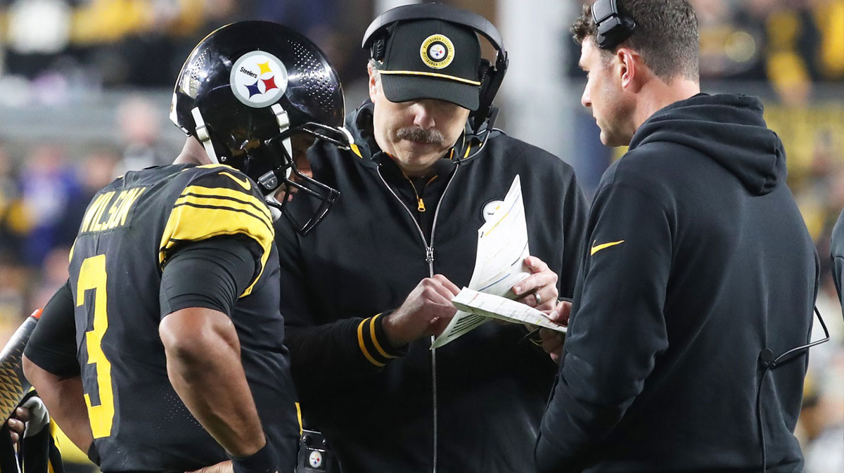 Pittsburgh Steelers quarterback Russell Wilson (3) talks with offensive coordinator Arthur Smith (middle) and quarterbacks coach Tom Arth (right) against the New York Giants during the fourth quarter at Acrisure Stadium.