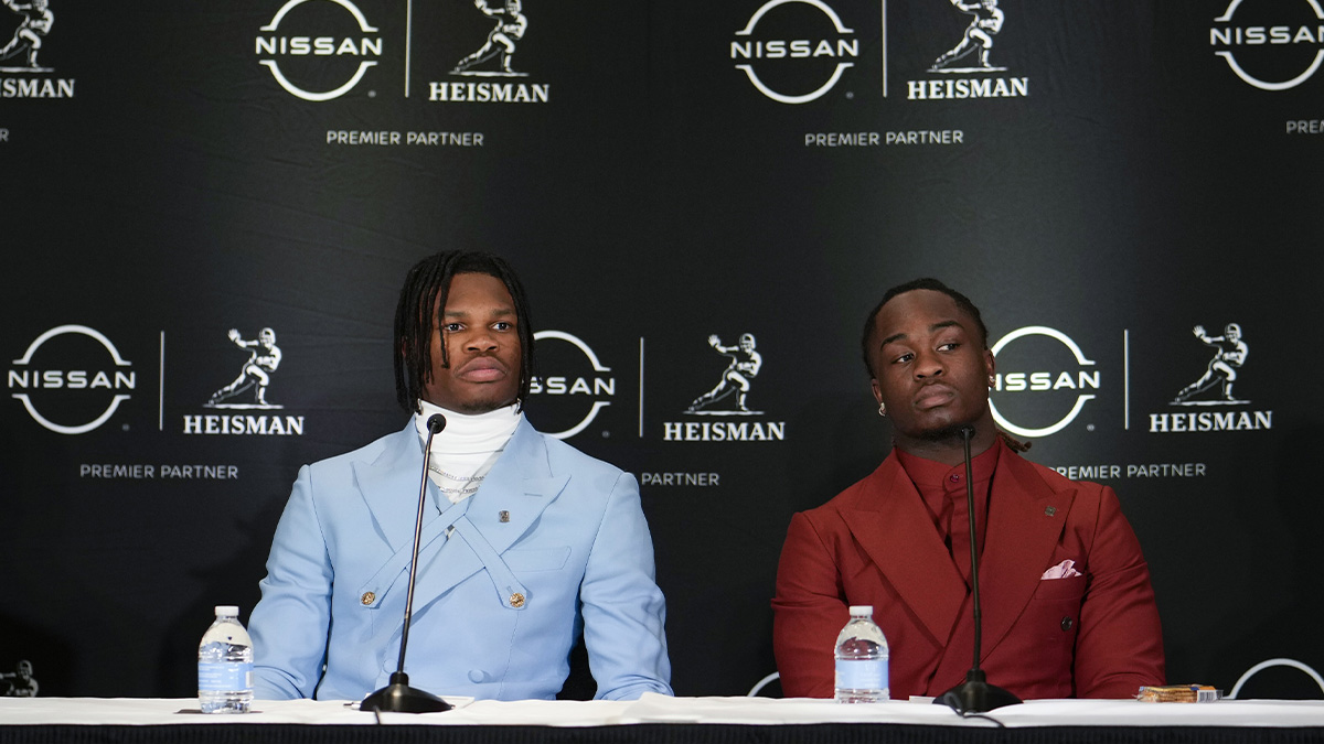Colorado Buffaloes wide receiver/cornerback Travis Hunter, left, and Boise State Broncos running back Ashton Jeanty speak on stage during a press conference before the 2024 Heisman Trophy Presentation.