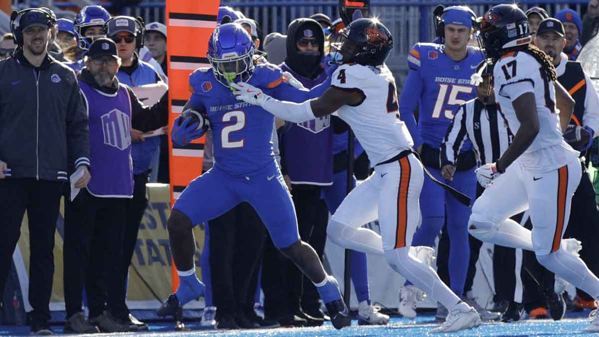 Boise State Broncos running back Ashton Jeanty (2) runs against Boise State Broncos safety Rodney Robinson (4) during the second quarter at Albertsons Stadium.