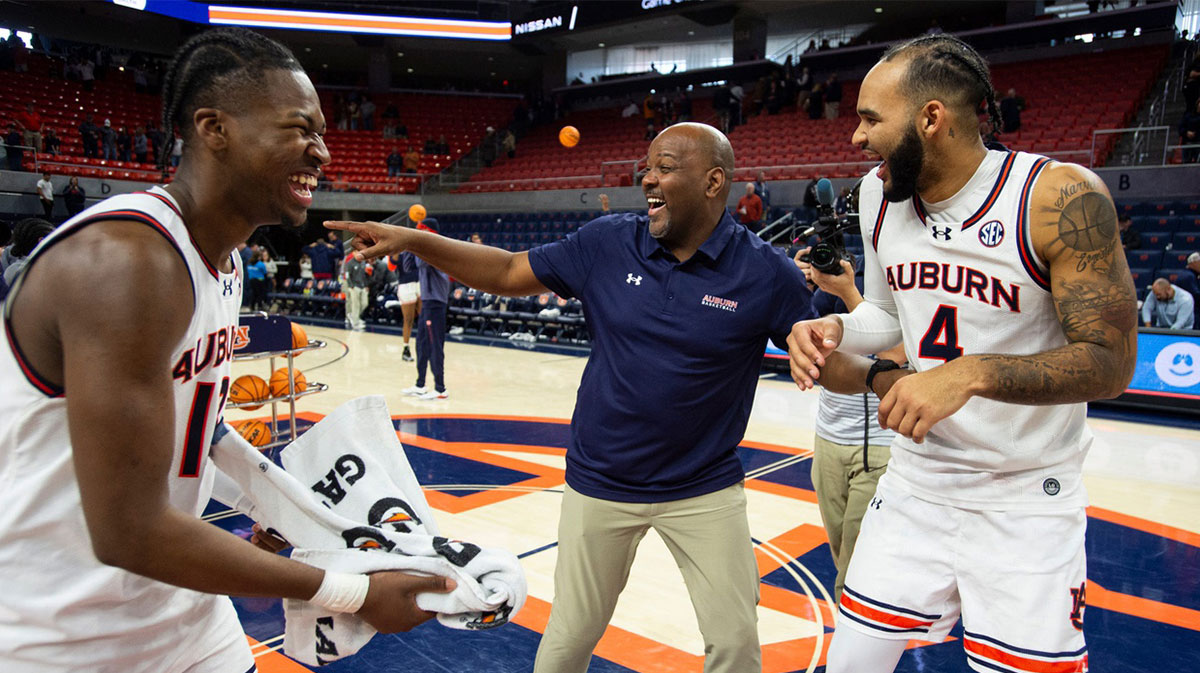 Auburn Tigers guard Miles Kelly (13), assistant coach Ira Bowman and forward Johni Broome (4) joke after the game as Auburn Tigers take on Richmond Spiders at Neville Arena in Auburn, Ala., on Saturday, Dec. 8, 2024. Auburn Tigers defeated Richmond Spiders 98-54.