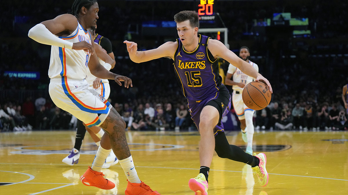 Los Angeles Lakers guard Austin Reaves (15) dribbles against Oklahoma City Thunder forward Jalen Williams (8) in the first half at Crypto.com Arena.