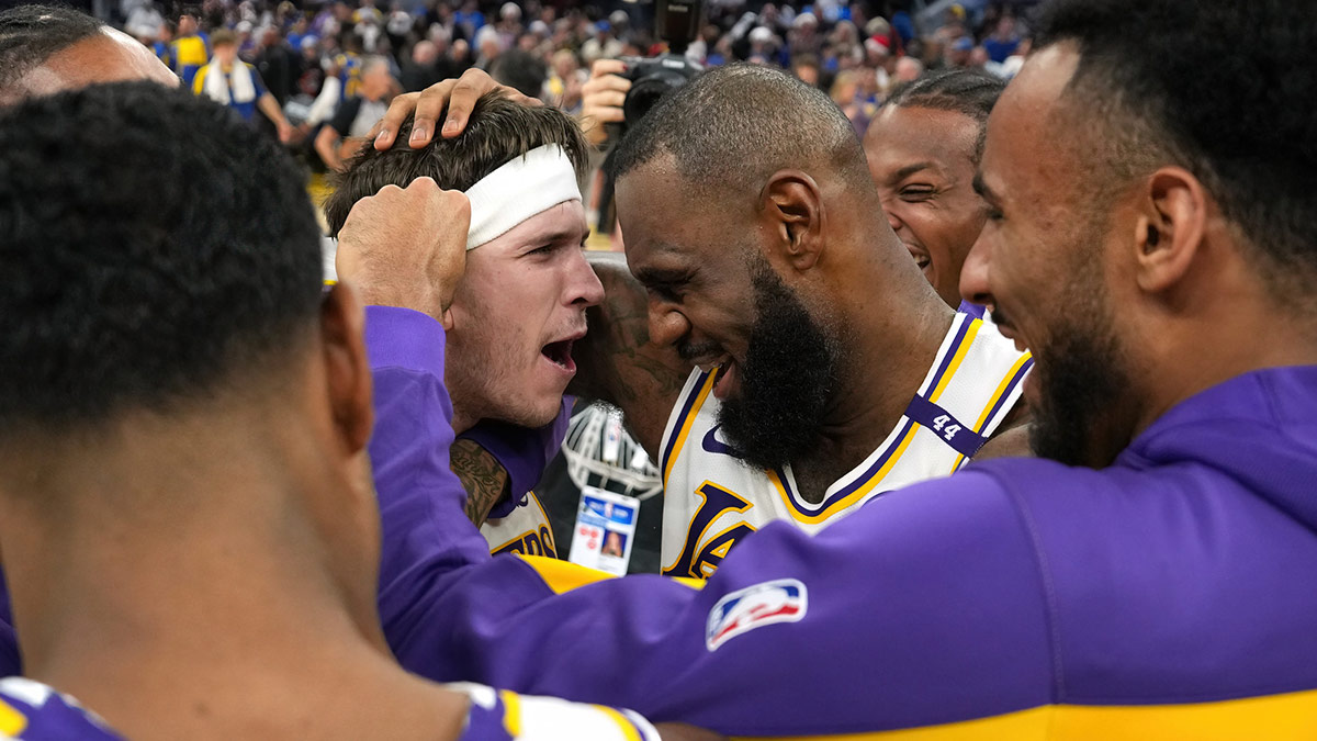 Los Angeles Lakers guard Austin Reaves (center left) is congratulated by forward LeBron James (center right) after making the game-winning basket to defeat the Golden State Warriors at Chase Center.