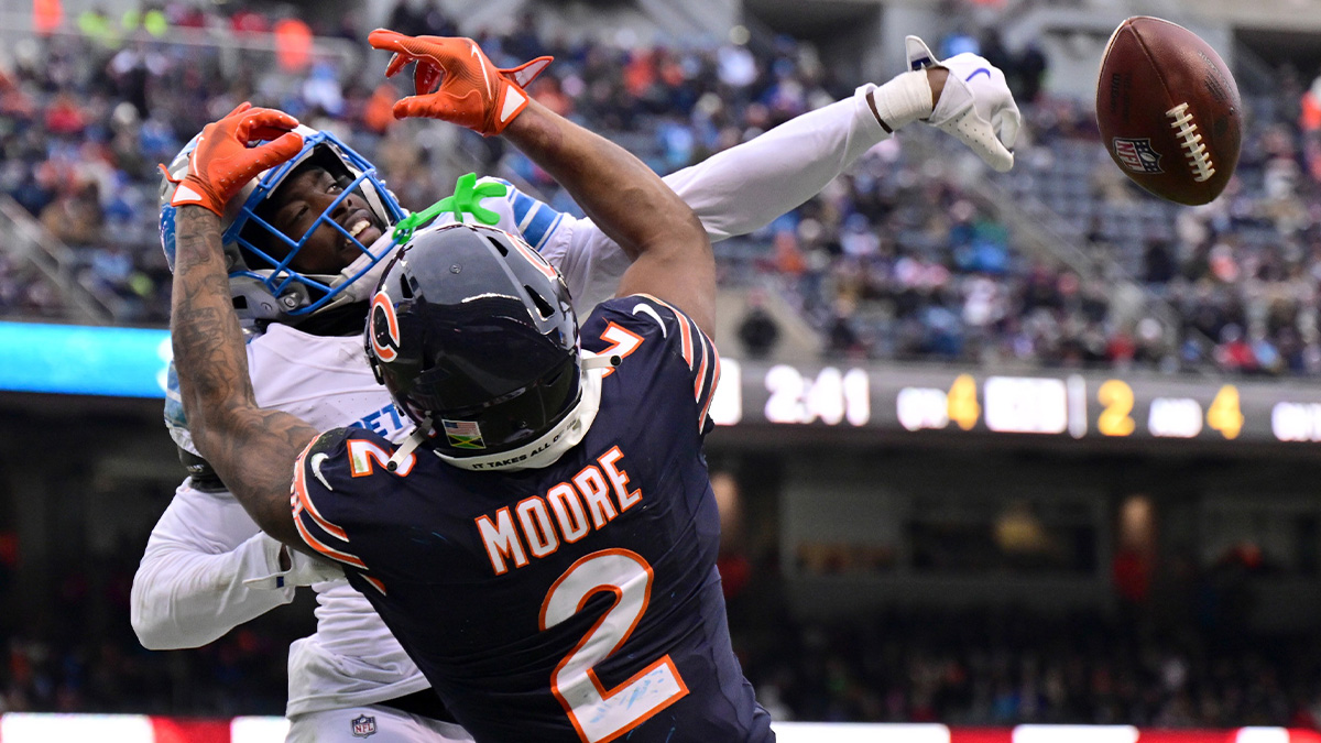 Detroit Lions cornerback Terrion Arnold (0) breaks up a pass intended for Chicago Bears wide receiver DJ Moore (2) during the fourth quarter at Soldier Field.